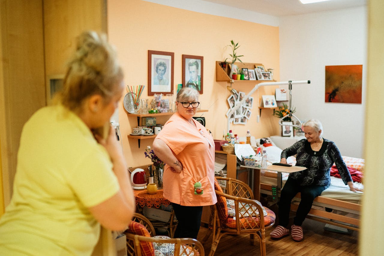 Crafting Captivating Headlines: Your awesome post title goes here Caregivers interacting with a senior woman in a cozy retirement home in Karviná, Czech Republic.