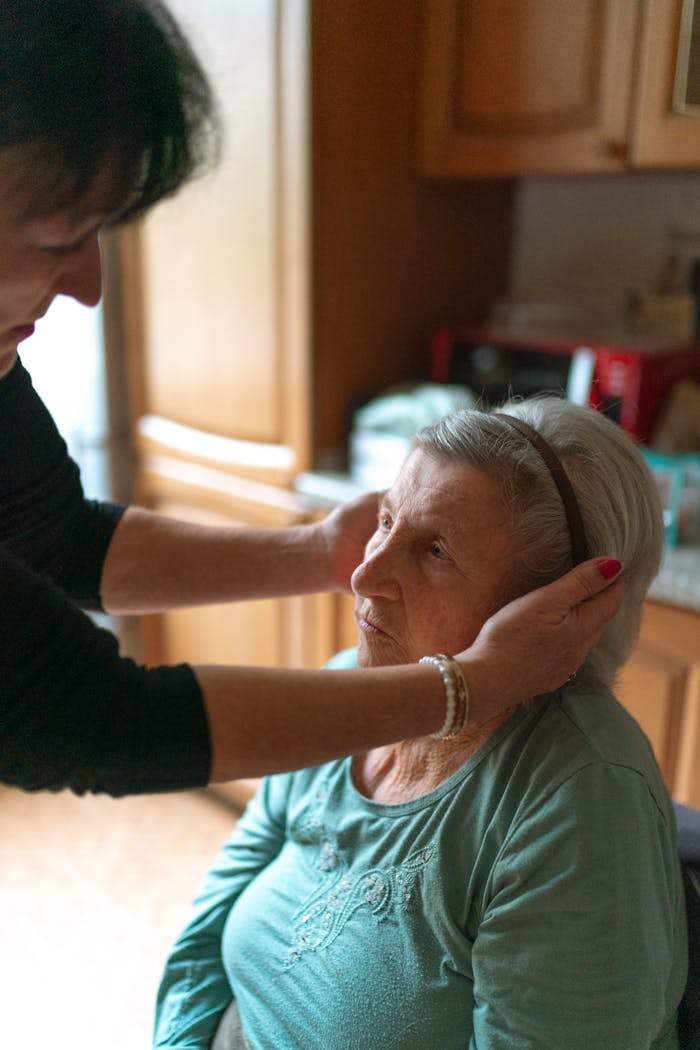 gallery-2 A senior woman receiving attentive home care assistance indoors, promoting comfort and support.