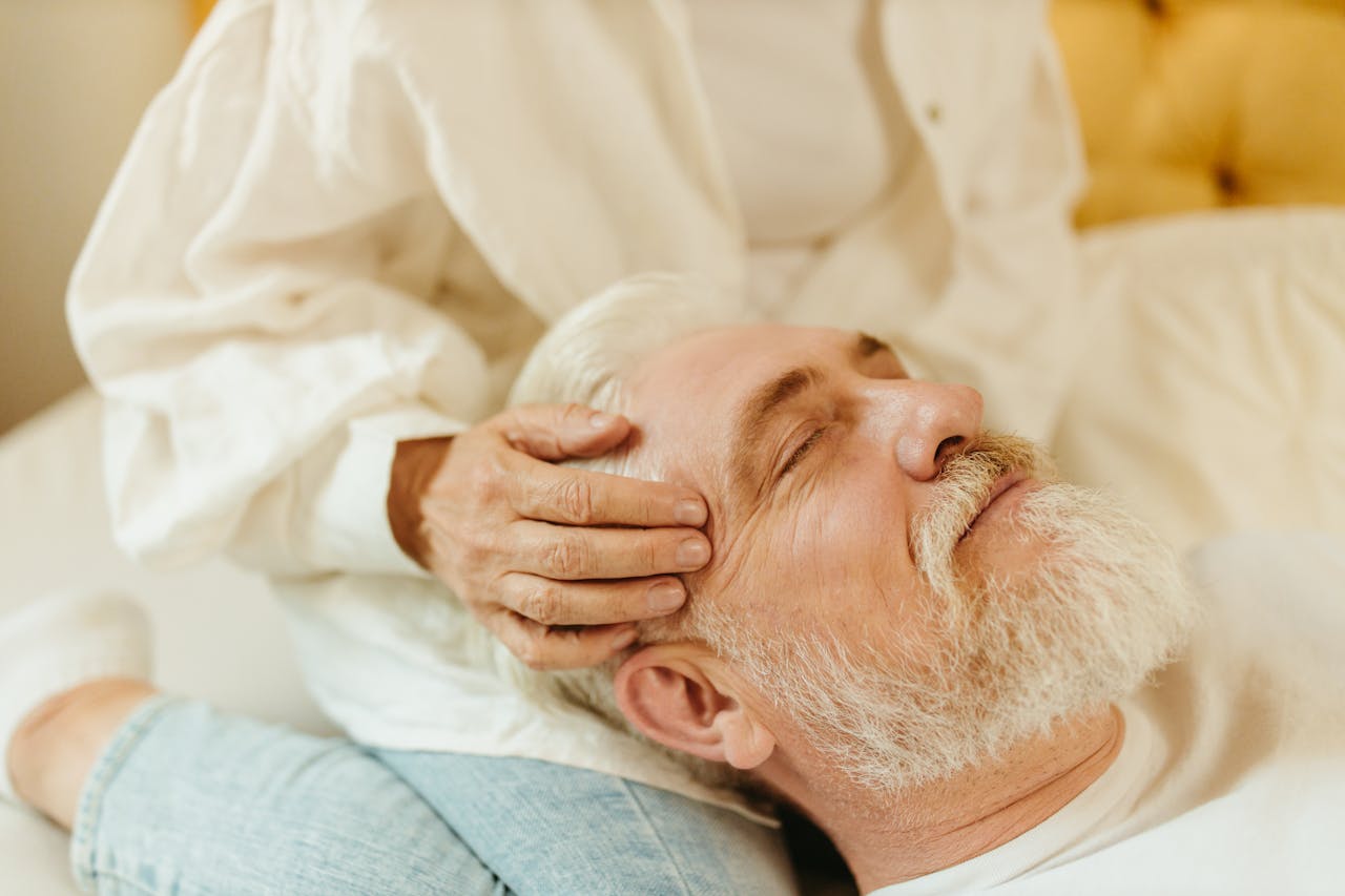 hero-img-02 Senior man enjoys a relaxing massage session indoors, highlighting wellness and calm.